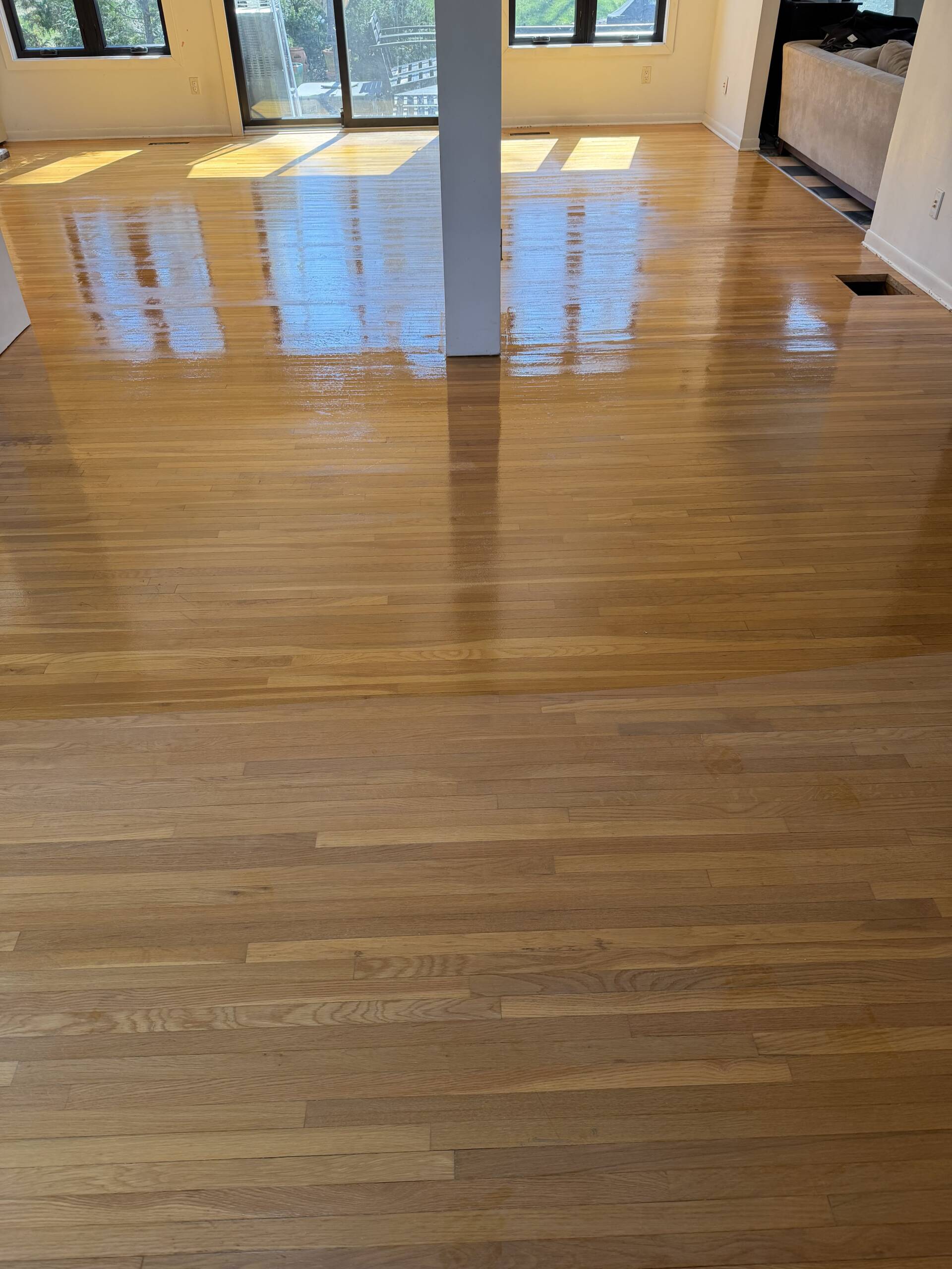 Hardwood floor in New jersey halfway coated by hardwood floor company to show the difference between coated and non coated hardwood